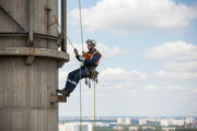 Rope access technician on industrial structure with ARMBURY D Steel Carabiner on harness