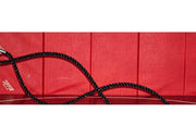 Battle-rope training detail with ropes anchored at weights; weights are not included